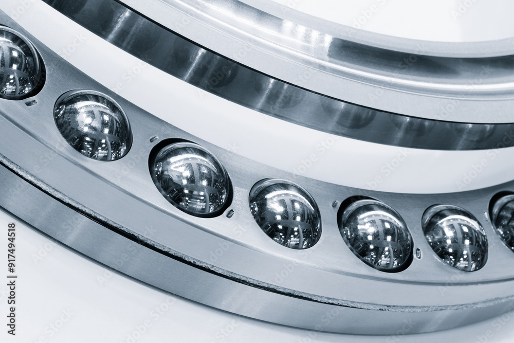 A close up of a ball bearing with a silver rim. Industrial metalworking concept background A close up of a ball bearing with a silver rim. Industrial metalworking concept background