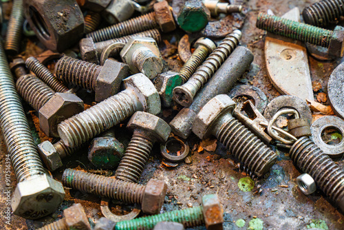 Metal working workshop with assorted screws, bolts, and nuts on a workbench covered in grime and tool remnants