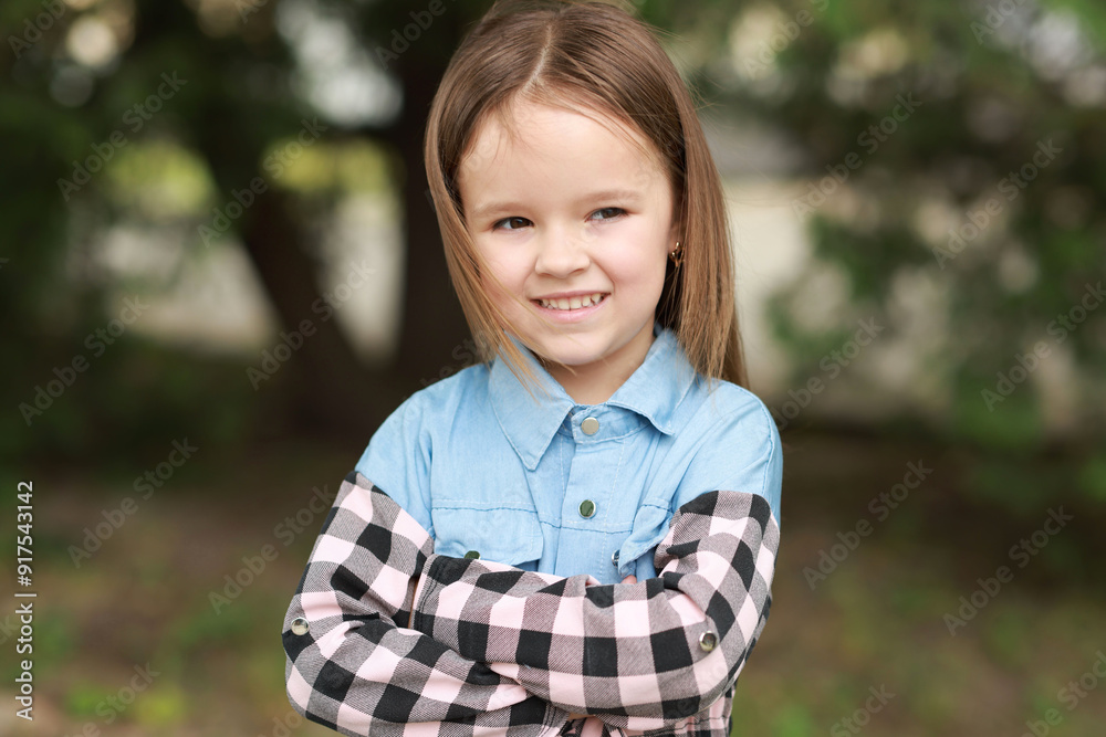 Portrait of happy little girl with crossed arms outdoors Portrait of happy little girl with crossed arms outdoors