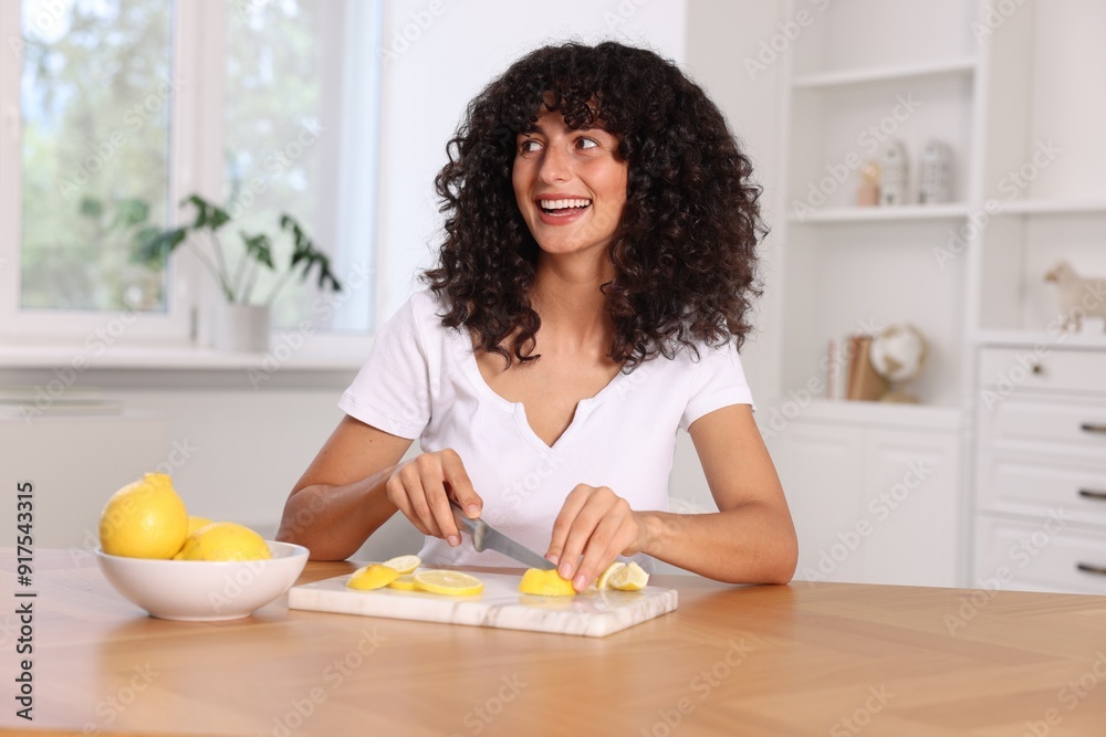 Making lemon water. Woman cutting fruit at wooden table indoors Making lemon water. Woman cutting fruit at wooden table indoors