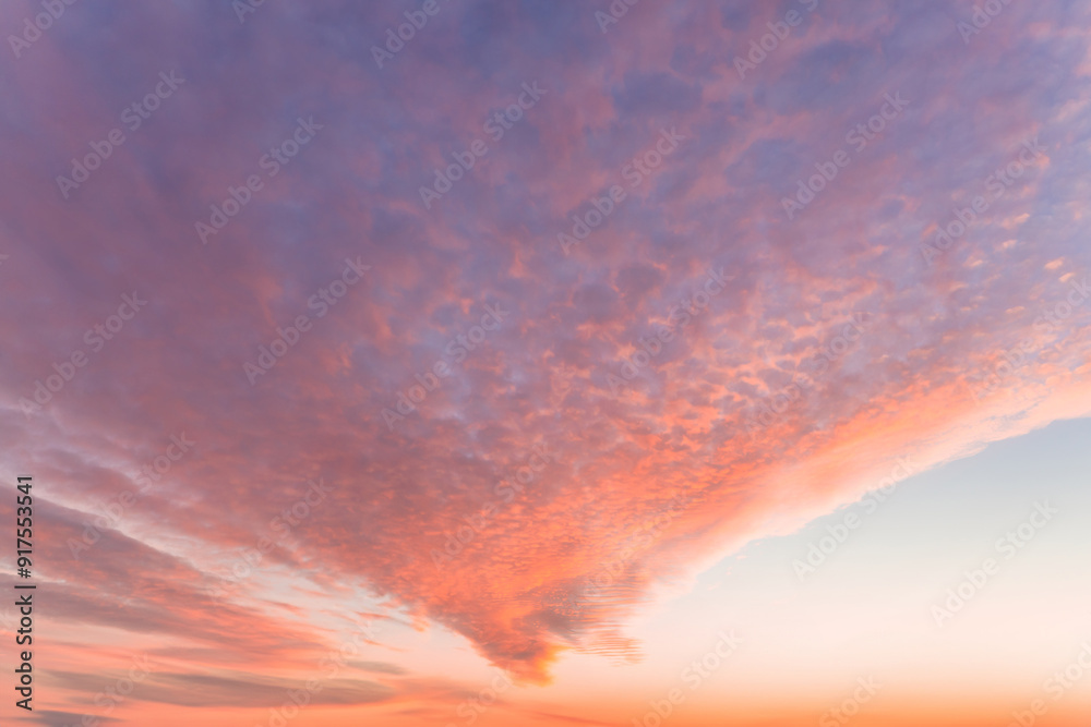 A beautiful sky tinted by the sun leaving vibrant shades of gold, pink, blue and multicolored. Clouds in the twilight evening and morning sky. Cloudy sky background in the evening and during the day. A beautiful sky tinted by the sun leaving vibrant shades of gold, pink, blue and multicolored. Clouds in the twilight evening and morning sky. Cloudy sky background in the evening and during the day.