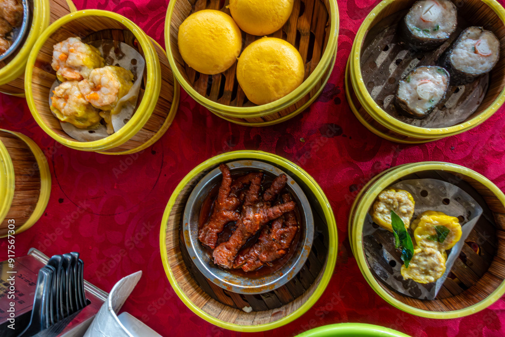 Looking down at dim sum in steamer baskets on a table at a restaurant in George Town, Penang, Malaysia. Looking down at dim sum in steamer baskets on a table at a restaurant in George Town, Penang, Malaysia.