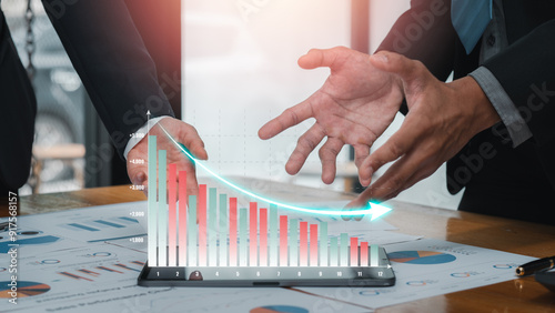 Business professionals analyzing cost reduction strategies with graphs and charts, showcasing financial planning and efficiency. photo