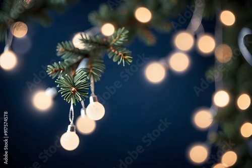 Christmas lights on a pine branch with a blue background.