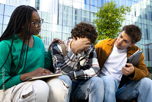 Fotografía Friends consoling and comforting upset and depressed young male college student
