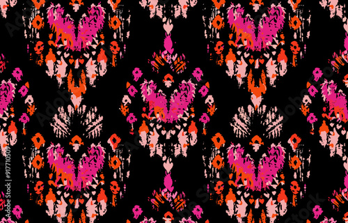 A vibrant seamless pattern in pink, red and orange hues, featuring a traditional ikat design on a black background. The intricate pattern is perfect for adding a touch of bohemian chic to any project.