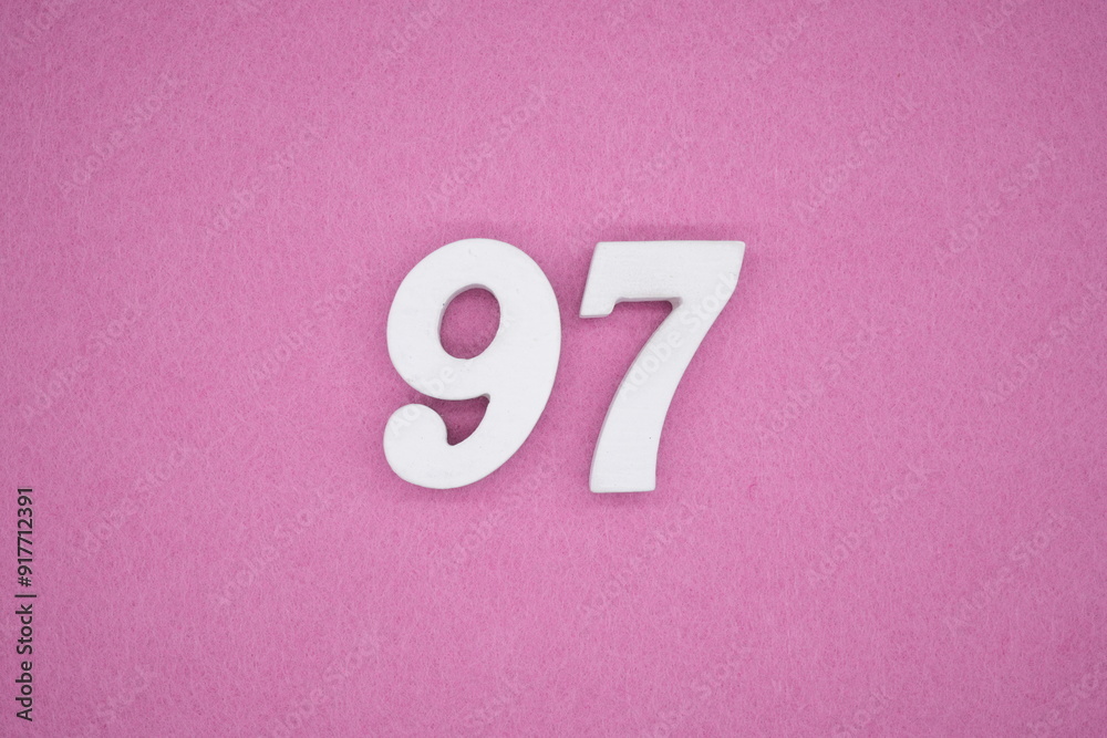 The numbers are made of white painted wood. Laying on the floor was pink paper. The numbers are made of white painted wood. Laying on the floor was pink paper.