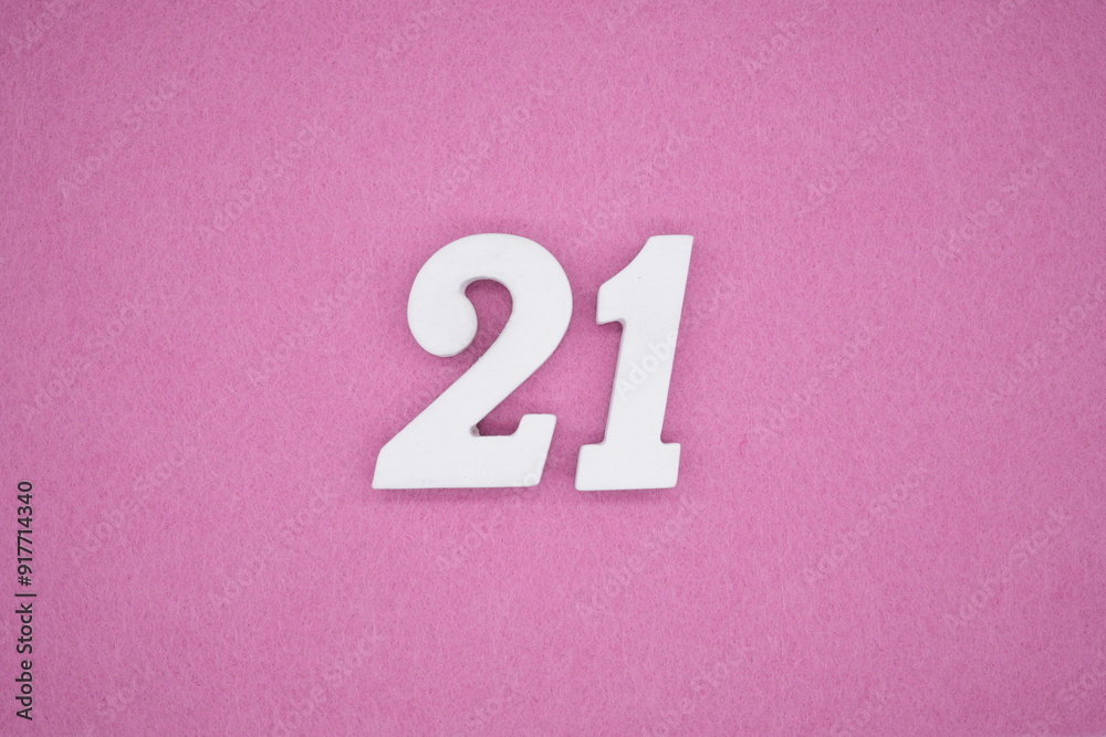 The numbers are made of white painted wood. Laying on the floor was pink paper. The numbers are made of white painted wood. Laying on the floor was pink paper.