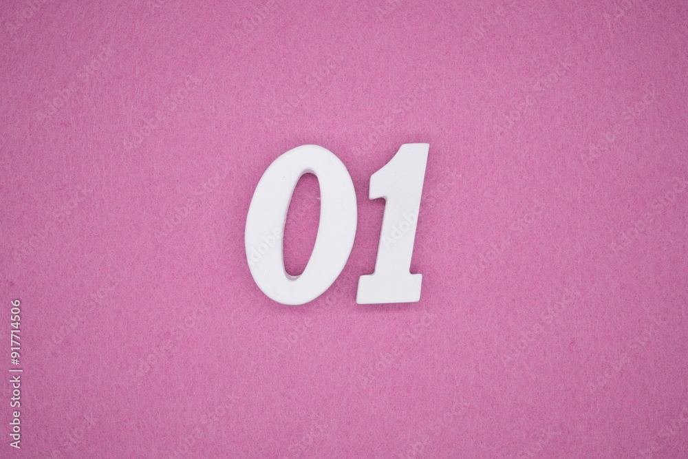 The numbers are made of white painted wood. Laying on the floor was pink paper.