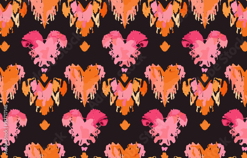 Seamless pattern with vibrant orange and pink watercolor abstract hearts on a black background, perfect for fashion, home decor, and stationery design.
