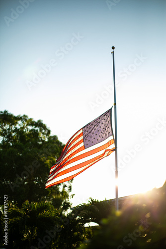 American Flag at half mast at sunset