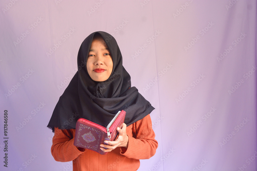Portrait of an Asian muslim women in a daily prayer at home reciting Surah al-Fatiha passage of the Qur'an in a single act of Sujud called a Sajdah or prostration Portrait of an Asian muslim women in a daily prayer at home reciting Surah al-Fatiha passage of the Qur'an in a single act of Sujud called a Sajdah or prostration