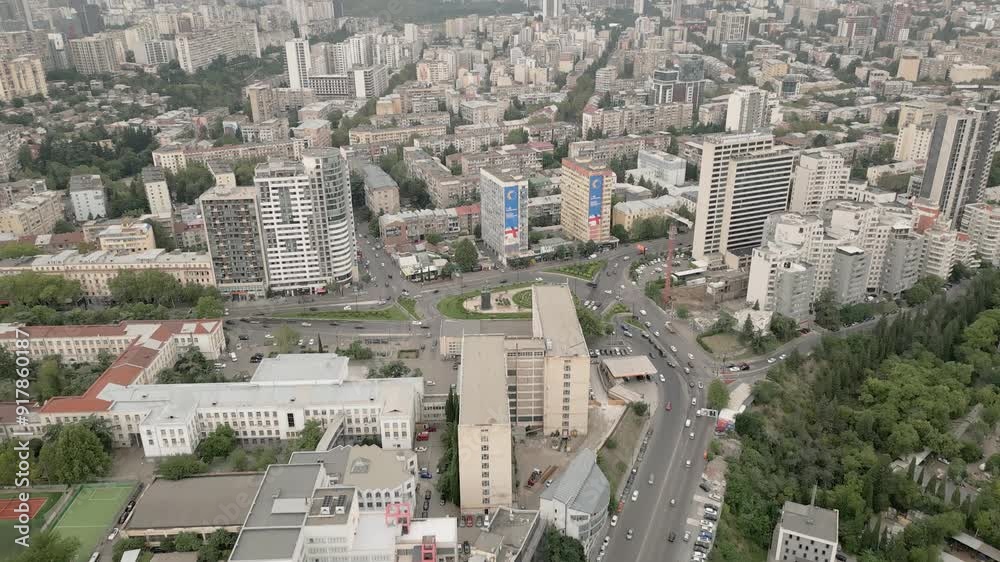 Aerial fly over new modern real estate block house buildings rooftops and streets with cars in Georgia capital city Tbilisi. Urbanization and real estate development concept Aerial fly over new modern real estate block house buildings rooftops and streets with cars in Georgia capital city Tbilisi. Urbanization and real estate development concept