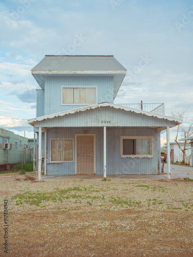 Weathered two-story house in a state of disrepair and abandonment