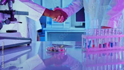 Hands Shaking in Chemistry Lab During Collaborative Research on Innovative Medical Technology