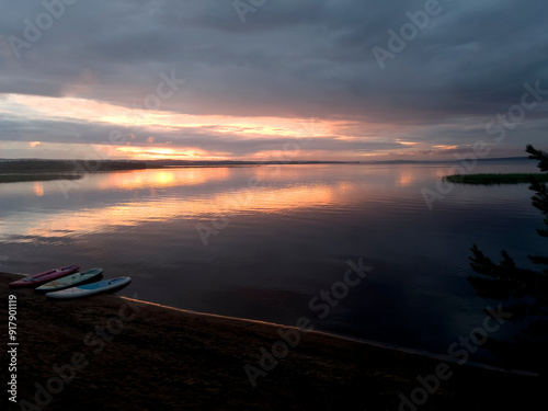 beautiful red sunset with an orange tint,relaxing on the lake shore with a kettle and tea with a hammock and a sap board for swimming and sports and health,outdoor recreationthe reservoir,summer photo