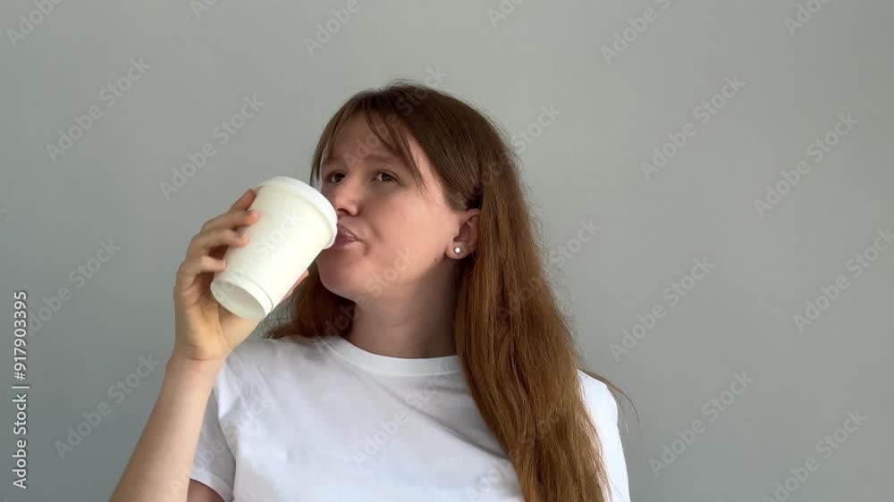 Waking up with coffee. Young sleepy woman drinking cup of coffee and yawn and then wake up and feel good Waking up with coffee. Young sleepy woman drinking cup of coffee and yawn and then wake up and feel good