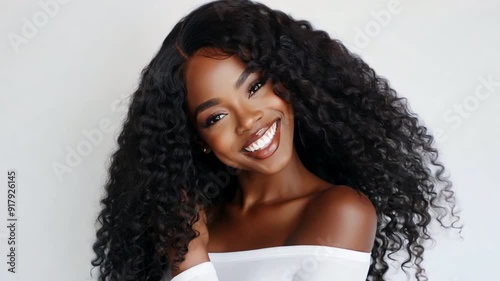 Beautiful girl with long curly hair wearing a white shirt