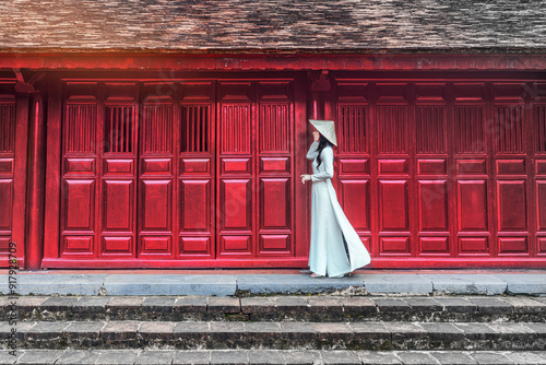 Asian girls  wearing Ao dai in Thien Mu temple. Hue,Vietnam. photo