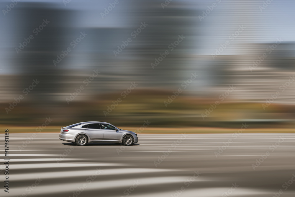 Car driving, fast motion on highway. Dynamic running car on road, blurred city background. Side view Car driving, fast motion on highway. Dynamic running car on road, blurred city background. Side view