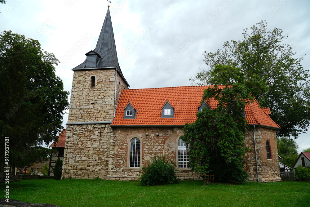 Fototapeta premium The Romanesque church of Saint Johannis in Nohra is an important small sacral building. The hall church was built in the 13th century. Nohra Bleicherode, district of Nordhausen in Thuringia, Germany.