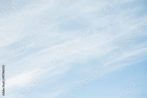 Fototapeta Naklejka Na Ścianę i Meble -  Milky sky with clouds resembling mist. Soft heaven texture of the sky. Hazy, foglike clouds providing a dreamy, heavenly atmosphere. Blue sky background. Bright clodus pattern.