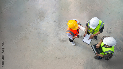 Top view of architects engineer are discussing about the progress of the building project and checking the accuracy of the building structure.