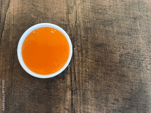 Chilies sauce dip cup on the wooden table