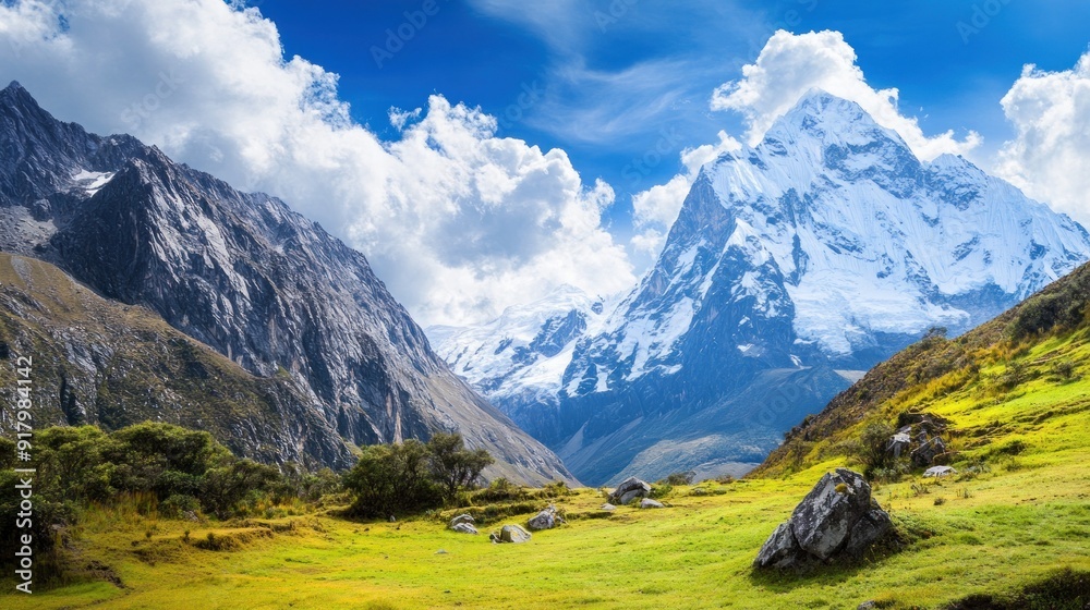 Majestic Snow-capped Mountain Peak with Green Meadow and Clouds Majestic Snow-capped Mountain Peak with Green Meadow and Clouds