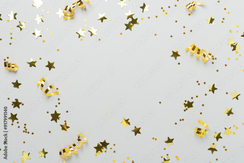Golden gift boxes and confetti on color background, top view Golden gift boxes and confetti on color background, top view