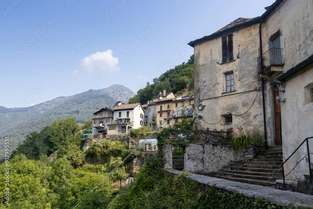 The quaint mountain village of Spoccia in the Cannobio Valley in Piedmont in Northern Italy. A car free historic village captured in the summer with clear sky and copy space above left. The quaint mountain village of Spoccia in the Cannobio Valley in Piedmont in Northern Italy. A car free historic village captured in the summer with clear sky and copy space above left.
