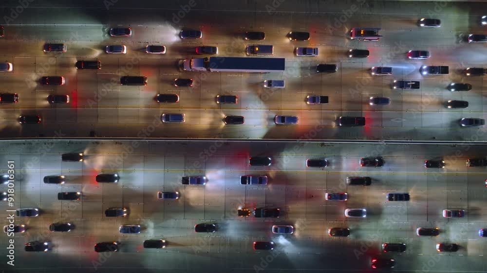 A 4K aerial image captures heavy traffic congestion in Downtown Los Angeles, California, USA, showing the chaotic city commute and bustling streets, with a busy urban scene full of cars and trucks