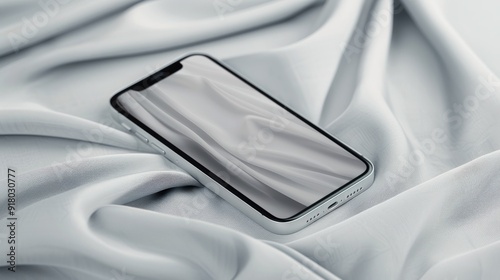 Mobile Phone Resting On Soft White Fabric In A Minimalist Setting