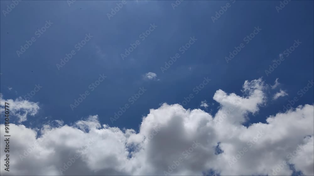 Cumulus clouds moving across the sky at midday Cumulus clouds moving across the sky at midday