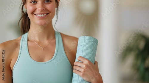 Young Woman Holding Yoga Mat in Fitness Studio During Morning Class