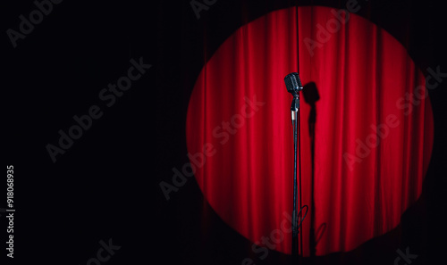Concept stand up, comedian show banner. Old microphone on theater stage on red curtains background