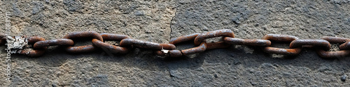 A simple, powerful image of a broken chain lying on the ground, symbolizing the strength of unionized workers. photo