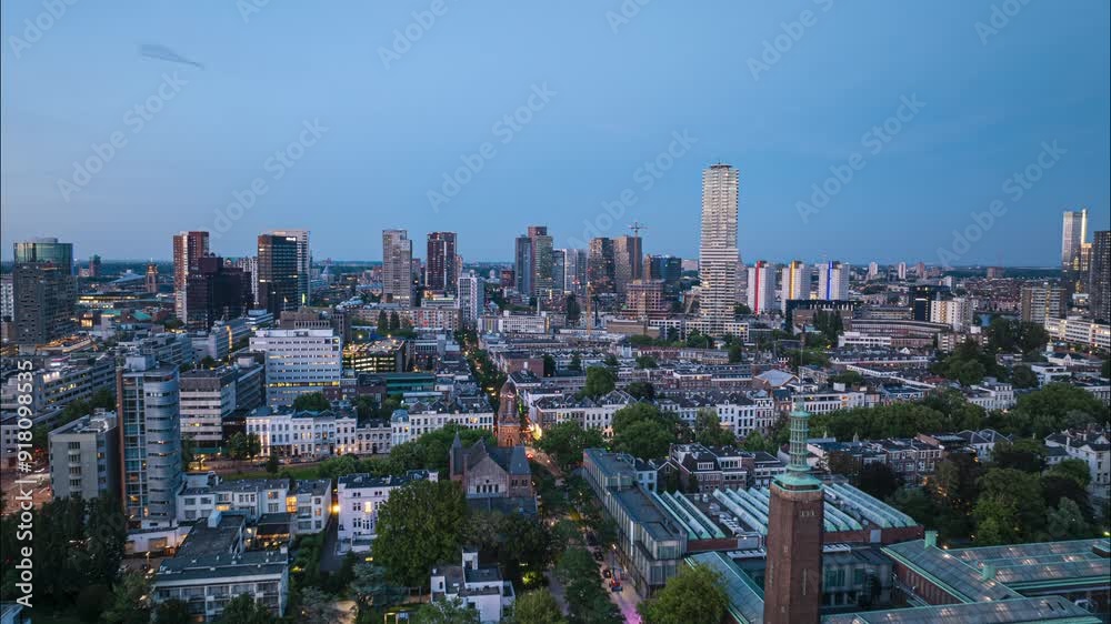Hyperlapse of the cityscape of rotterdam at twilight, showcasing sleek skyscrapers and colorful city lights and highlighting urban growth and modern architecture