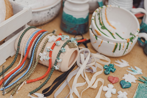 Colorful handmade pottery and vibrant jewelry displayed at a craft fair in the afternoon sun photo