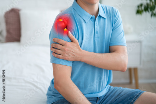Dislocation of the shoulder, joint inflammation, arthritis and degenerative changes, man with pain in hand at home