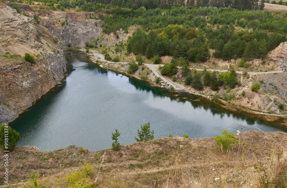 Rock formations in an abandoned quarry with a lake Rock formations in an abandoned quarry with a lake