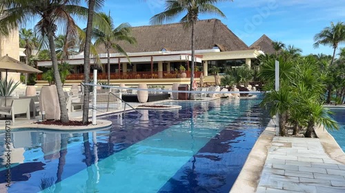 Swimming pool with volleyball net ready to play volleyball in an all-inclusive luxury resort hotel in the middle of a tropical setting in the heart of the Riviera Maya.