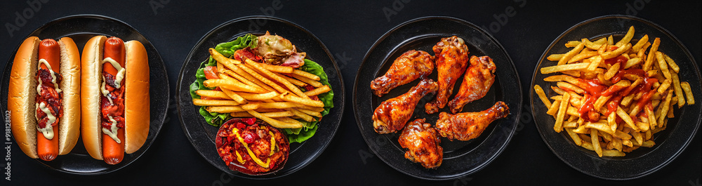 Fast food, hot dog, chicken, french fries on black background. Fast food, hot dog, chicken, french fries on black background.