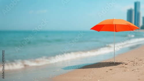 Orange Umbrella on Sandy Beach by the Calm Ocean Under Clear Sky
