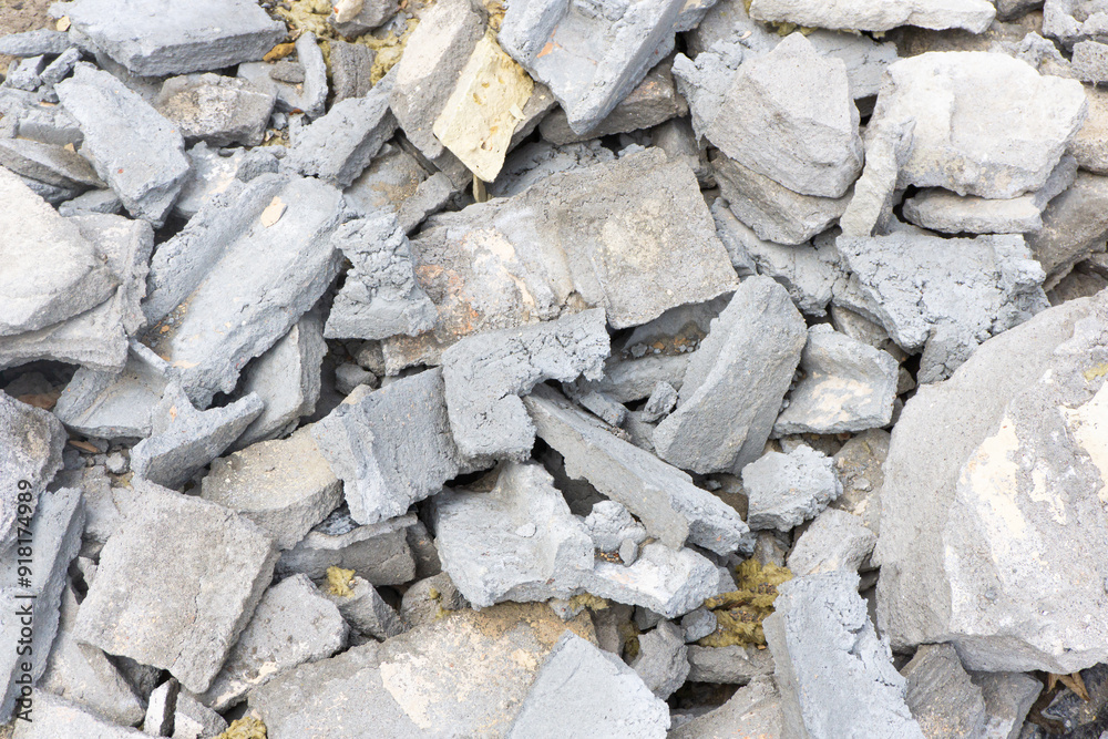 Post renovation debris. Concrete, brick, and gypsum fragments. Dirty dusty texture. Broken materials and construction waste texture. Extensive building work. Cracked bricks. Dusty trash background.
