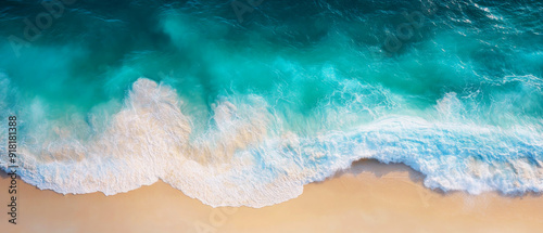 Aerial view of turquoise waves on sandy beach