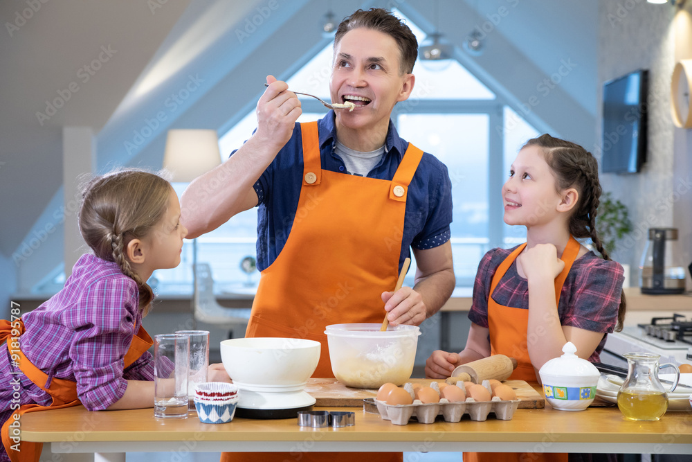 Family cooking in the kitchen at home