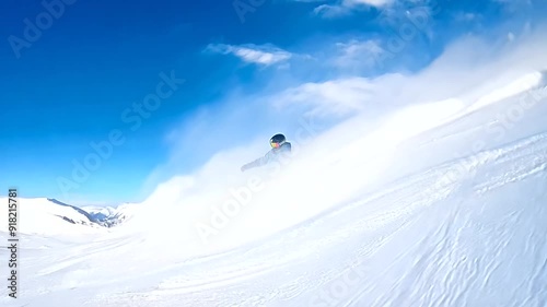 High-speed snowboarding down steep, powdery slopes, kicking up fresh snow in an adrenaline-fueled winter adventure. photo