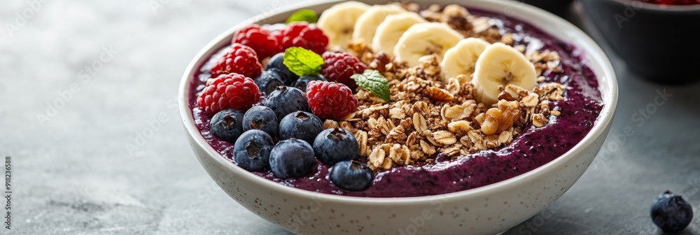 Delicious Acai Bowl with Fresh Berries, Banana, and Granola - A vibrant acai bowl topped with fresh blueberries, raspberries, banana slices, granola, and a sprig of mint. It's a healthy and refreshing Delicious Acai Bowl with Fresh Berries, Banana, and Granola - A vibrant acai bowl topped with fresh blueberries, raspberries, banana slices, granola, and a sprig of mint. It's a healthy and refreshing