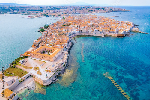 Aerial of Ortigia island, old town with turquoise sea of Syracuse. Small island on Sicily, Italy.